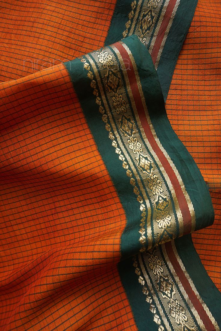 Traditional orange and green saree fabric weave pattern